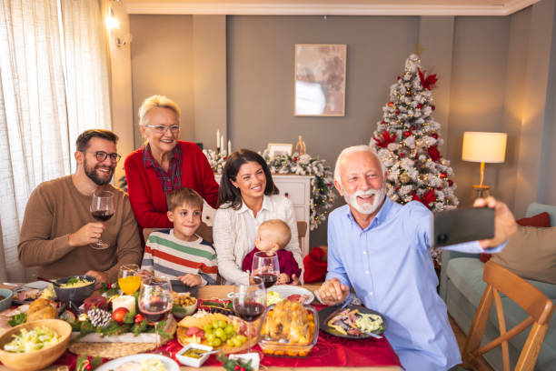 istock Family taking a selfie while having Christmas dinner at home 1794925472