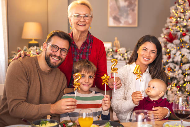 istock Happy family holding numbers 2024 while having Christmas dinner 1794930349