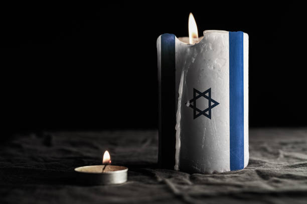 istock Burning candle with Israel flag on black background 1794937317