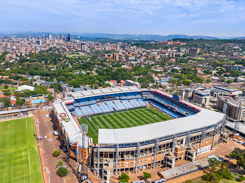 Loftus Versveld Stadium in Pretoria, home of the Blue Bulls Rugby Club with Pretoria cityscape panorama in the background.