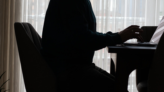 Laptop and laptop on table near window curtains