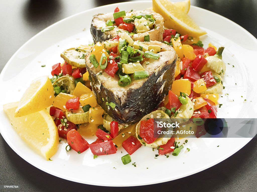 Dinner Steamed and baked sturgeon with stir-fry vegetables. Shallow dof. Baked Stock Photo