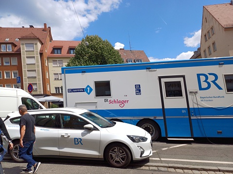 Nuremberg, Germany - June 10, 2023: Close up of an outside broadcast van ( OB van ) of ARD broadcaster, is parked on a street. Outside broadcast of a television program.