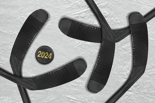 Hockey gloves, stick and puck on the ice rink. Concept, hockey, wallpaper