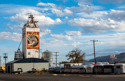 Fruita, Colorado, USA- November 7, 2023: Co op grain elevator with a dinosaur mural, Fruita, Colorado.