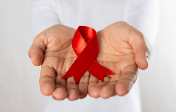 istock Woman Holding Red Awareness Ribbon 1794982225