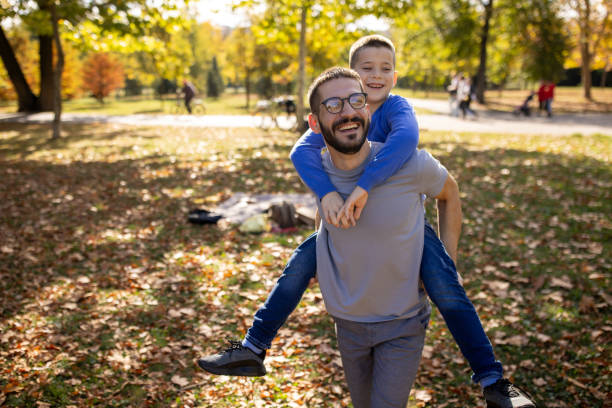istock Father carrying his son on his back while on a picnic 1794983353
