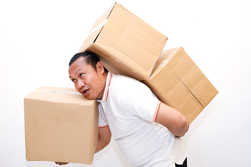 asian man lifting cardboard isolated white background