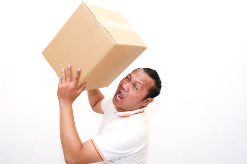 asian man lifting cardboard isolated white background