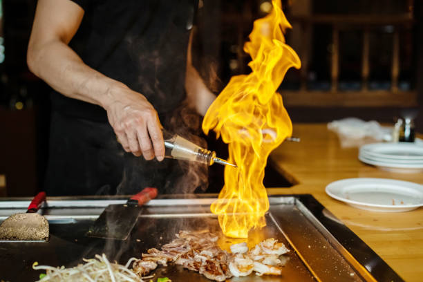istock Chef cooking in Japanese teppanyaki restaurant 1794985396