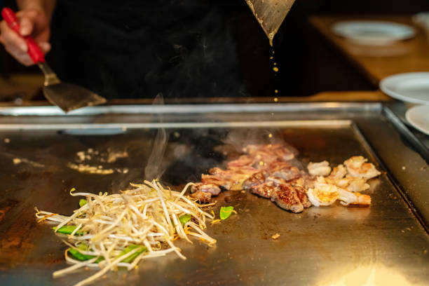istock Chef cooking in Japanese teppanyaki restaurant 1794985406