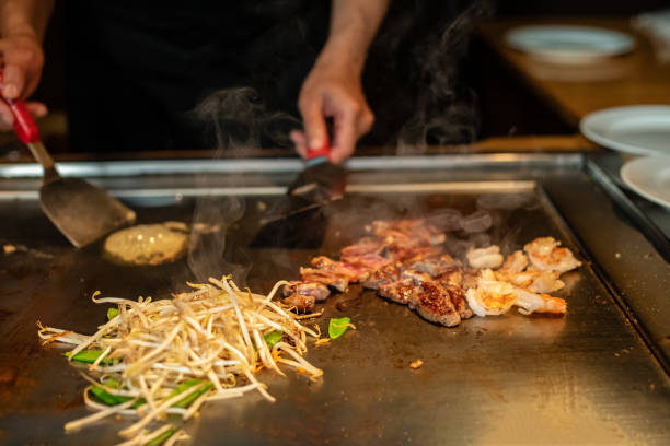 istock Chef cooking in Japanese teppanyaki restaurant 1794985420
