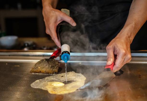 istock Chef cooking in Japanese teppanyaki restaurant 1794985509