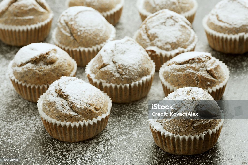 Muffins with icing sugar A fresh batch of muffins with icing sugar. Arrangement Stock Photo