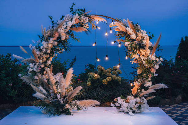 istock Arch at the wedding ceremony. Outdoors decoration. Romantic rustic style. Lamps lights in the evening. 1794991697