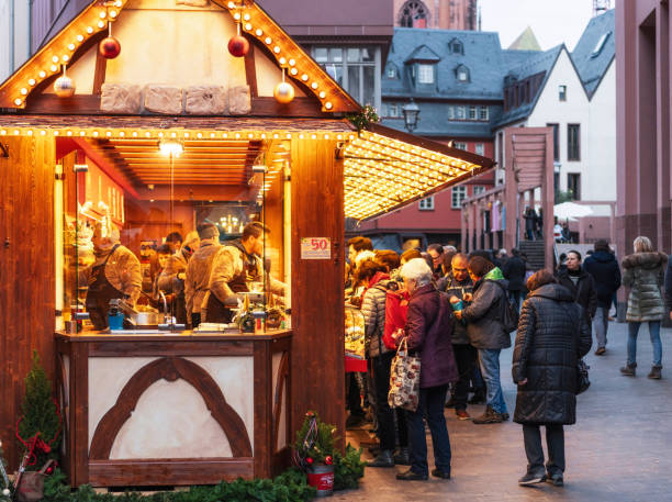Frankfurt, Germany - Customers at a busy market food stall in central Frankfurt during December.