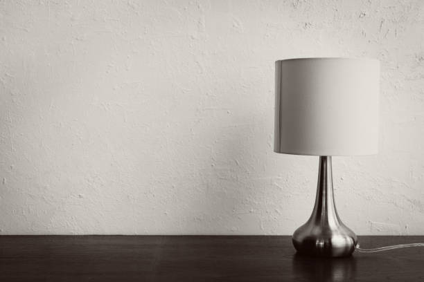 istock minimal simple elegant lamp on wooden table against white wall 1794998229