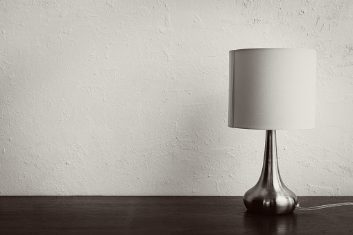 minimal simple elegant lamp on wooden table against white wall