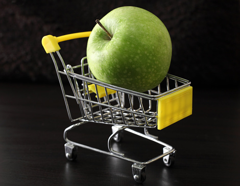 Green apple in a supermarket trolley.