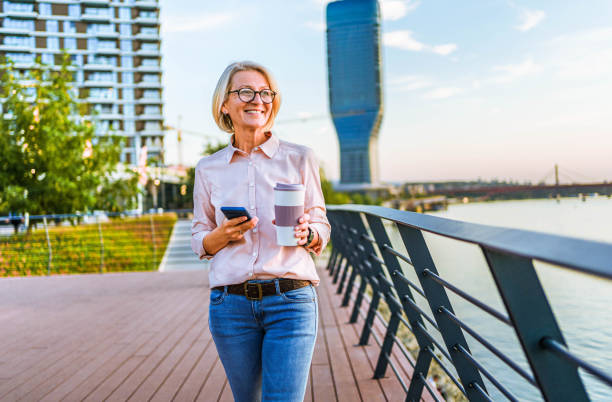 istock Mature woman enjoying a walk by the river 1795005104