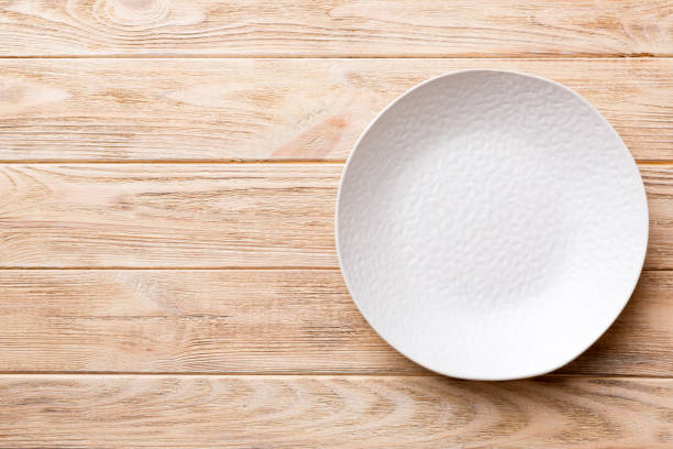 istock Top view of empty blue plate on wooden background. Empty space for your design 1795005117