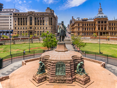 Paul Kruger Statue with the Ou Raadsaal, the Town Hall seen above right, the Standard Bank on the left. Paul Kruger's bronze statue was sculpted by artist Anton Van Wouw in 1896.