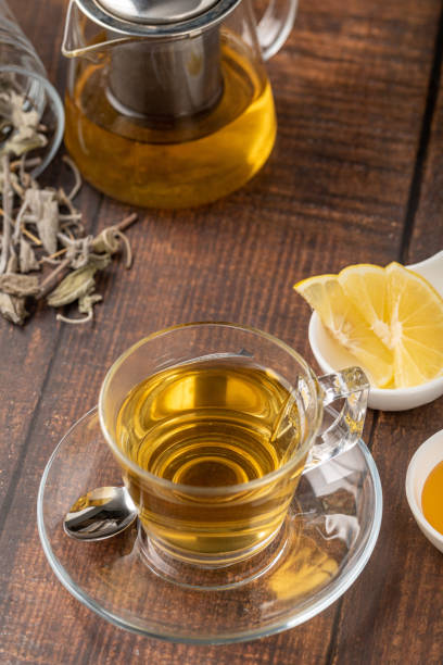 istock Dried sage tea in glass cup on wooden table 1795011814
