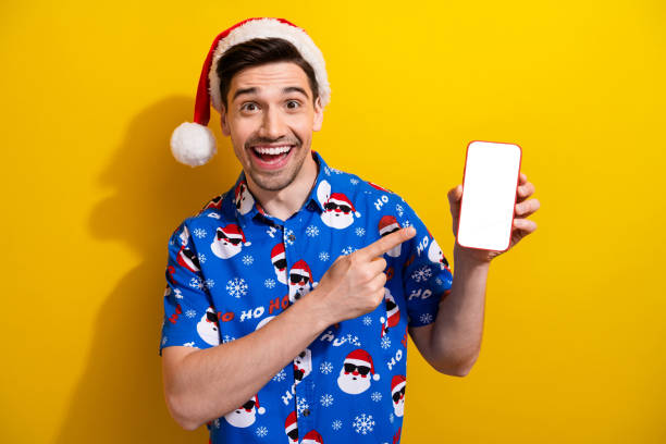 istock Photo of surprised funky guy indicate finger empty space smart phone display offer isolated on yellow color background 1795021484