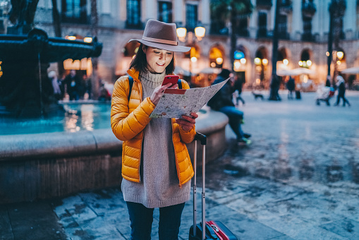 Businesswoman in Barcelona using a map for navigation in the city