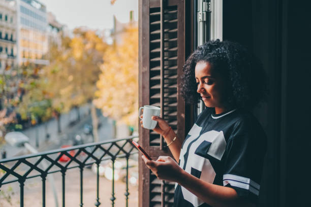 istock Woman drinking coffee and texting at home 1795031914