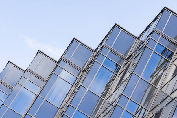 istock Office facade corners made of steel framework and shiny glass 1795036748