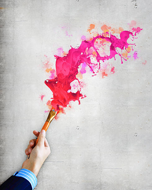 Human hand holding paint brush