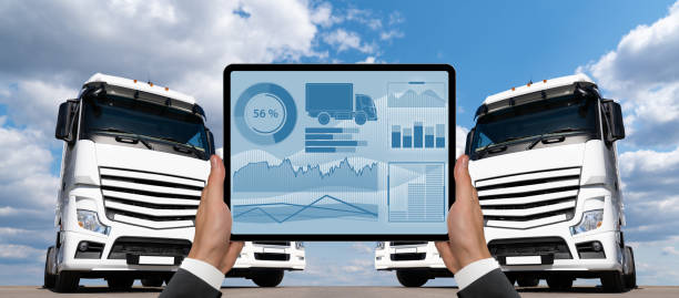 istock Manager with a digital tablet on the background of trucks 1795062523