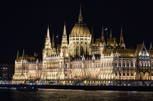 Parliament building in Budapest, Hungary is one of the most beautiful parliament building in Europe. Built in gothic style on Danube river waterfront. Photo taken at evening when building is illuminated.