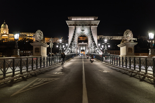 Chain bridge in Budapest, Hungary is one of the well known landmarks in this beautiful east European city. It's connecting two part of city Buda and Pest. Photo taken at night with vehicles blurred in motion. Budapest Castle in background