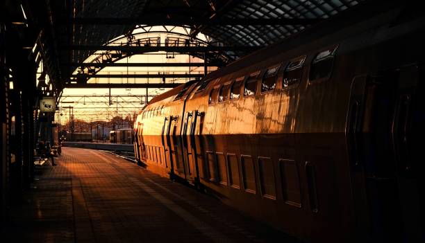 istock a train stopped at a railway station with a sun setting 1795065787