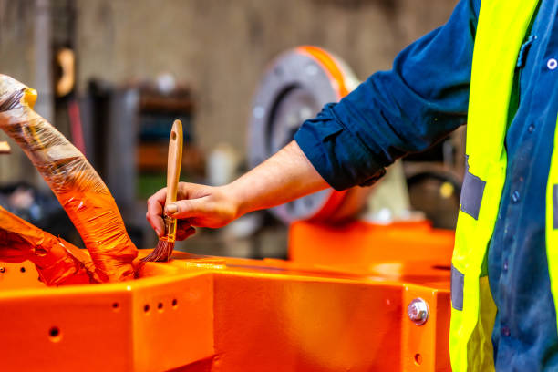 istock A worker painting a part of a robotic arm 1795070726