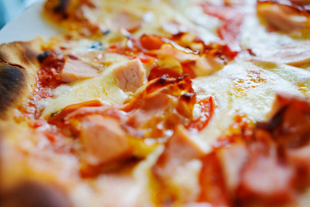 Close-up of cheese with bacon pizza.