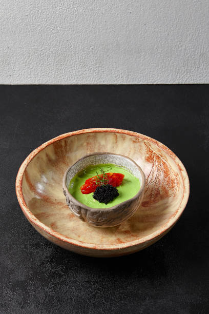 avocado cream with minced tomato and caviar. guacamole sauce in handmade ceramic bowl. modern food - avocado dip. healthy appetizers from avocado. vegetarian spread. - guacamole food bar vegan food imagens e fotografias de stock