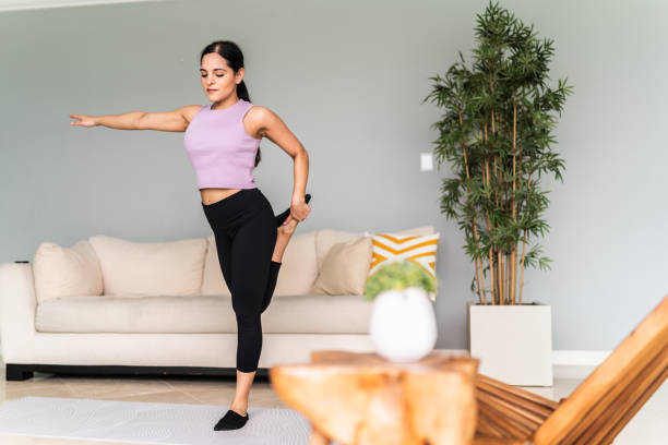 istock Young woman stretching at home 1795087749