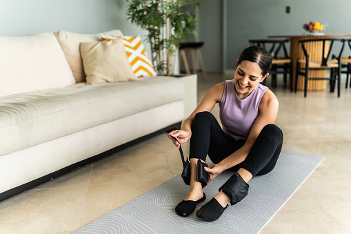 Young woman preparing to exercise at home