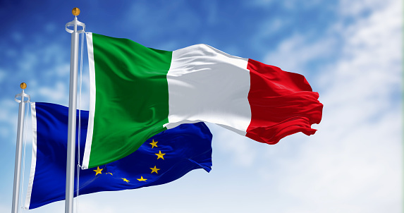 National flag of Italy waving in the wind with the European Union flag on a clear day. 3d illustration render. Rippling fabric