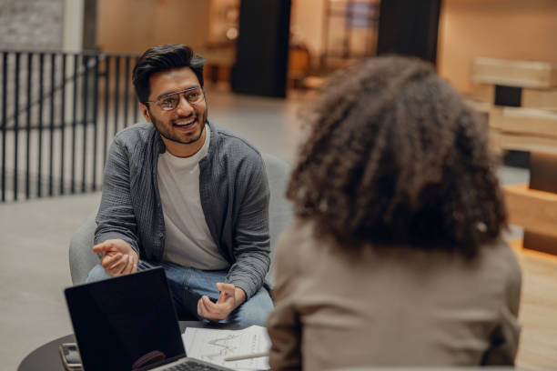 istock Smiling coworkers working together and talking at modern office. Workplace and cooperation concept 1795115029