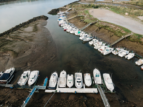Aerial view of a small leisure port with boats in a marsh area