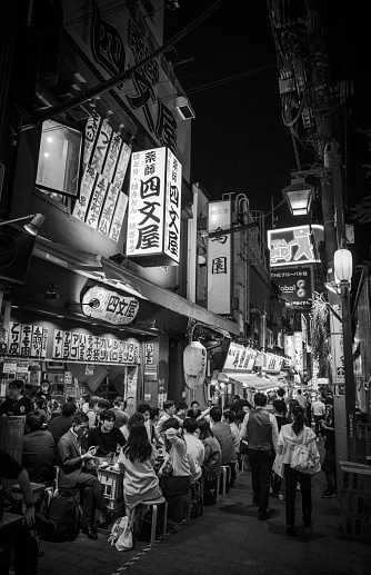 Tokyo, Japan - October 20, 2023:  Bustling alleyway in the city's vibrant Shinjuku neighborhood.