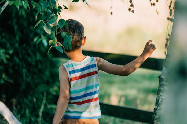 istock Back side view on little boy in village 1795147827