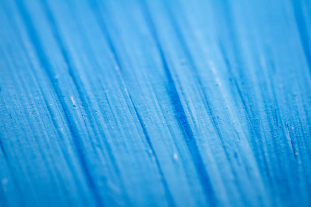 Extreme close up of blue acrylic paint texture showing brush strokes. Selective focus.