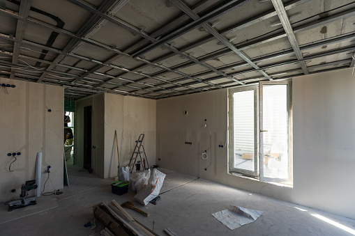 Drywall installation work in progress by construction workers at construction room. easiest and cheapest way to do partition for interior wall. New home for under construction. protection building . High quality photo