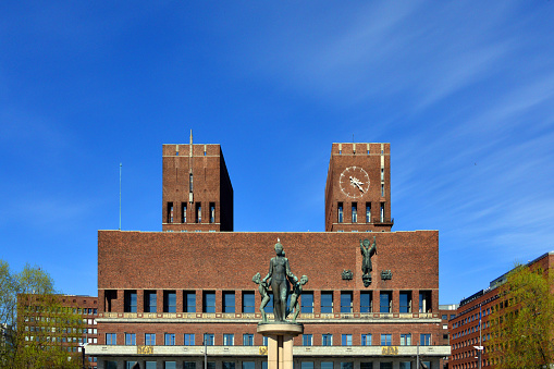 Oslo, Norway: Oslo City Hall (Oslo rådhus) - built 1931–1950 according to drawings by the architects Arnstein Arneberg and Magnus Poulsson . The town hall is located in the center of Oslo on the north side of Pipervika, the south façade faces Rådhusplassen, the town hall piers (Rådhusbryggene) and the Honnørbryggen pier by the Oslo Fjord. It is the venue for the yearly awarding of the Nobel Peace Prize.