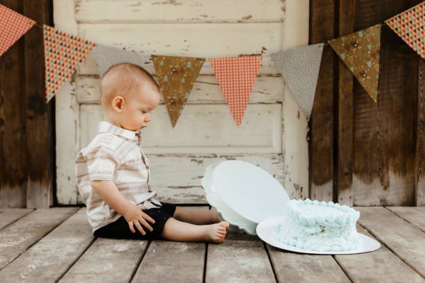 istock One Year Old Baby Boy With Birthday Cake 1795223651